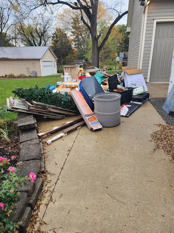 Dumpster being loaded with debris for Residential Dumpster Rental in Providence